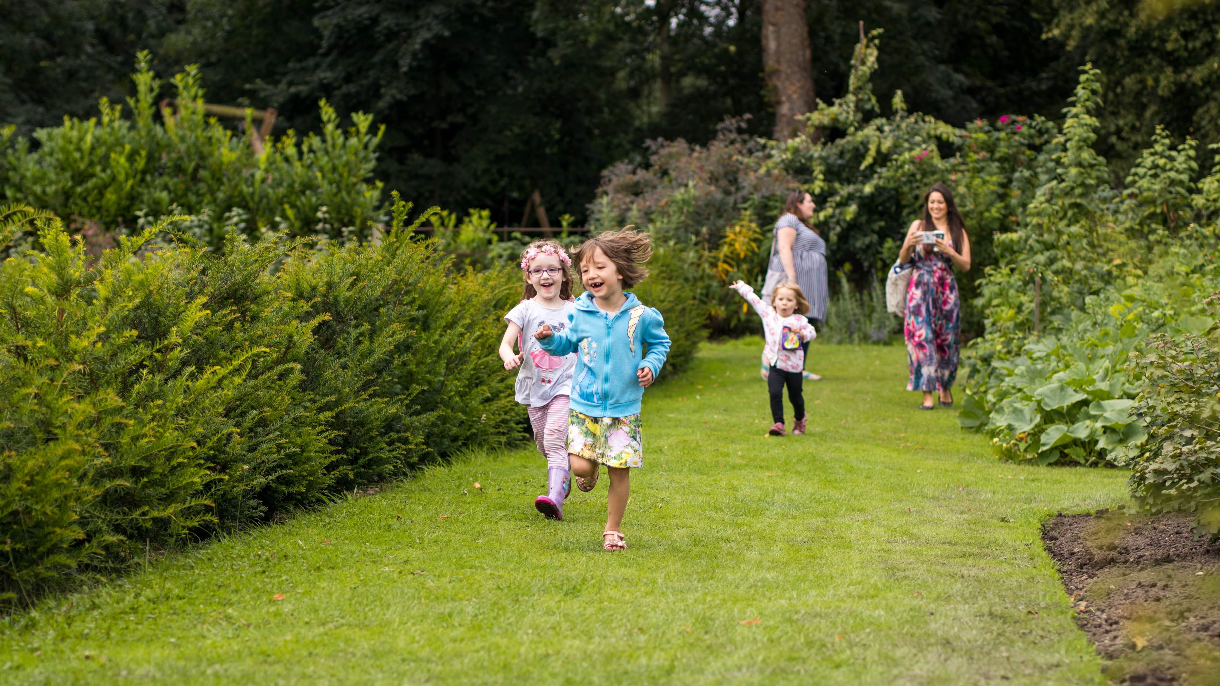 Family visitors in Summer in the garden at Nostell Priory, West Yorkshire