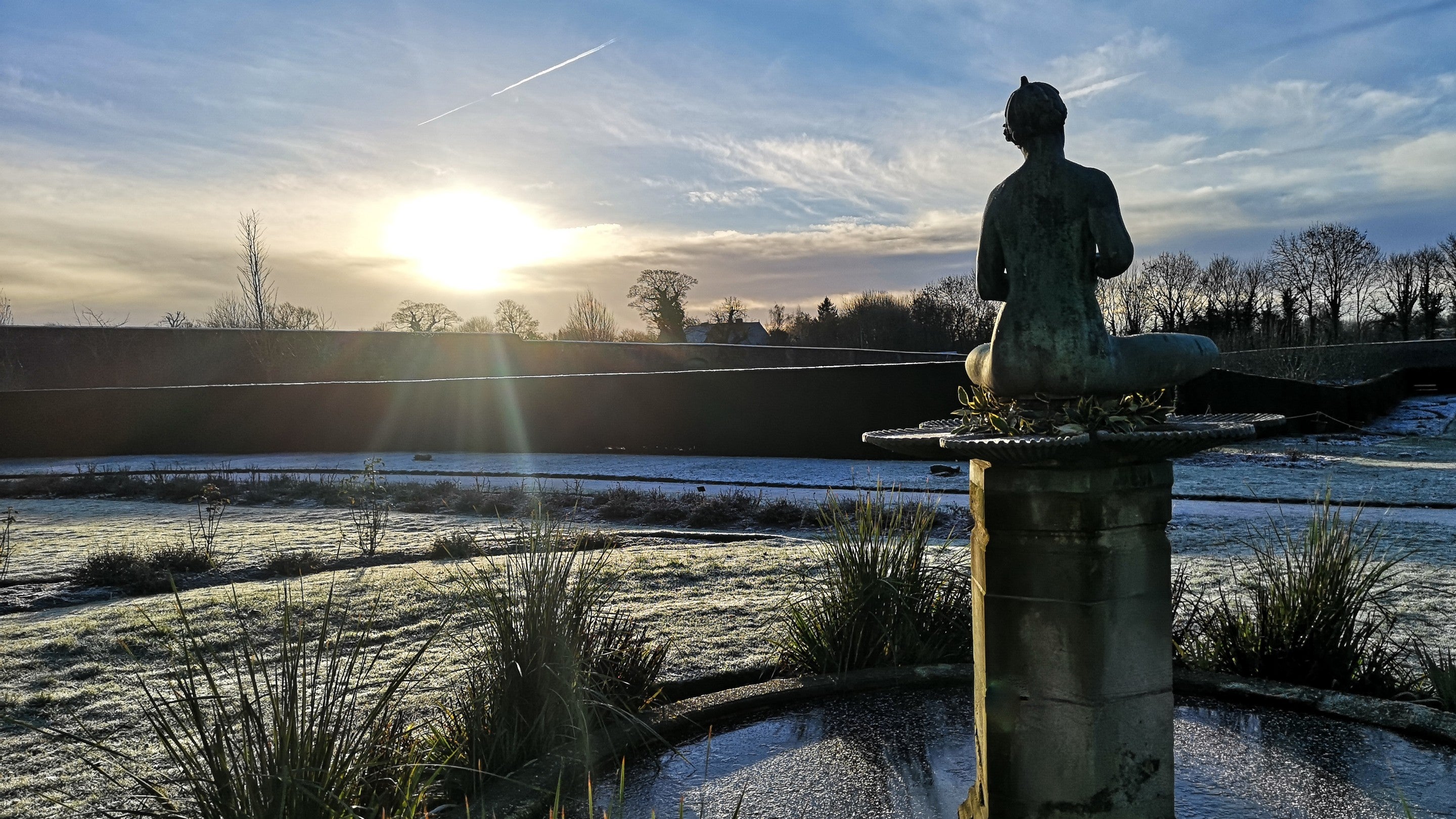 Frosty morning in the garden at Nostell with fountain and statue in the foreground