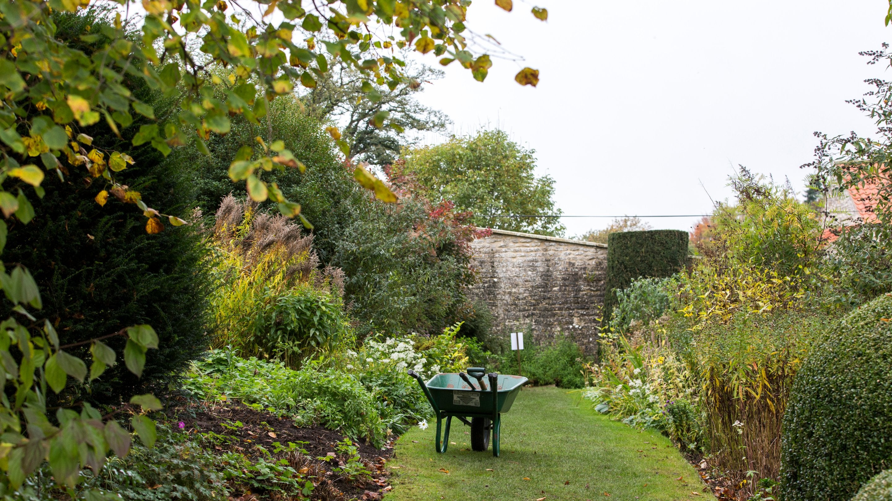 Wheelbarrow in the garden of Nunnington Hall, North Yorkshire, in autumn