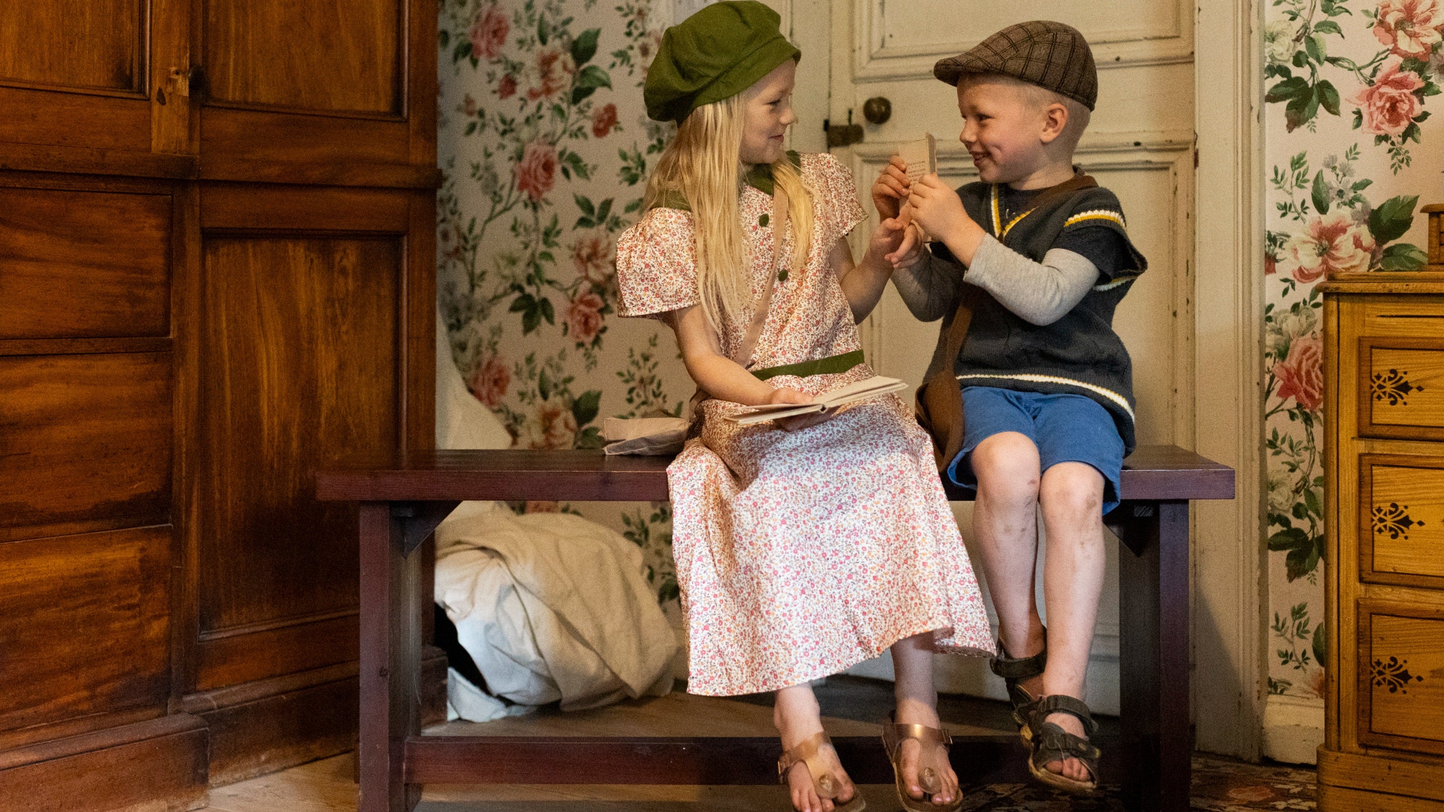 Children enjoying dressing up in 1940s costumes in the west bedroom at Nunnington Hall