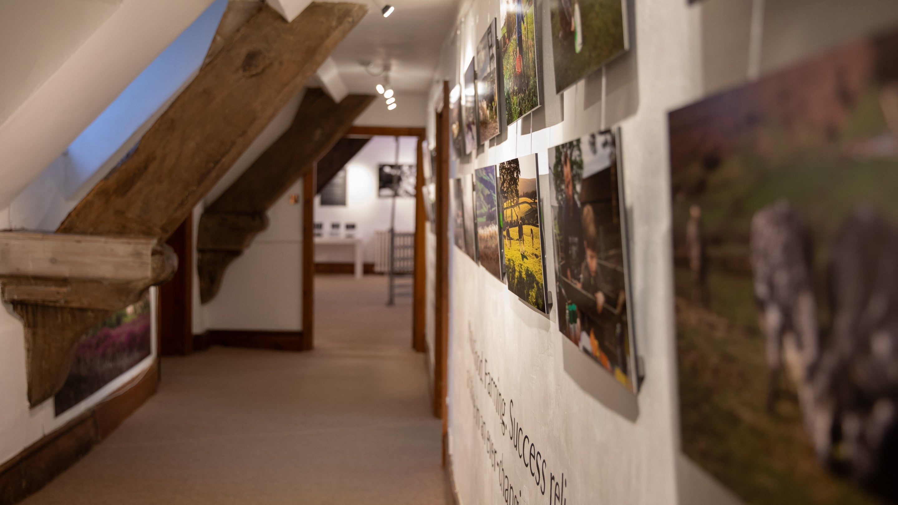 Long view down the corridor with artwork displayed on the wall to the right in Nunnington's Gallery