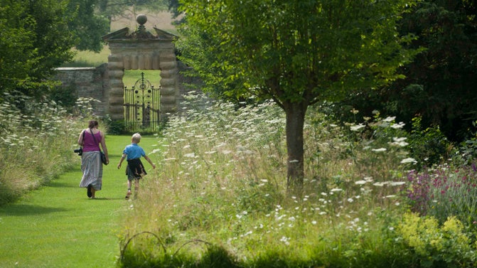 Visitors exploring the gardens at Nunnington Hall, North Yorkshire