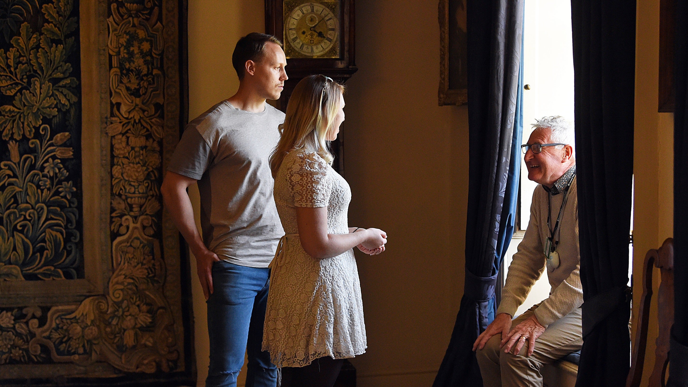 Volunteer room guide speaking with visitors at Nunnington Hall, North Yorkshire