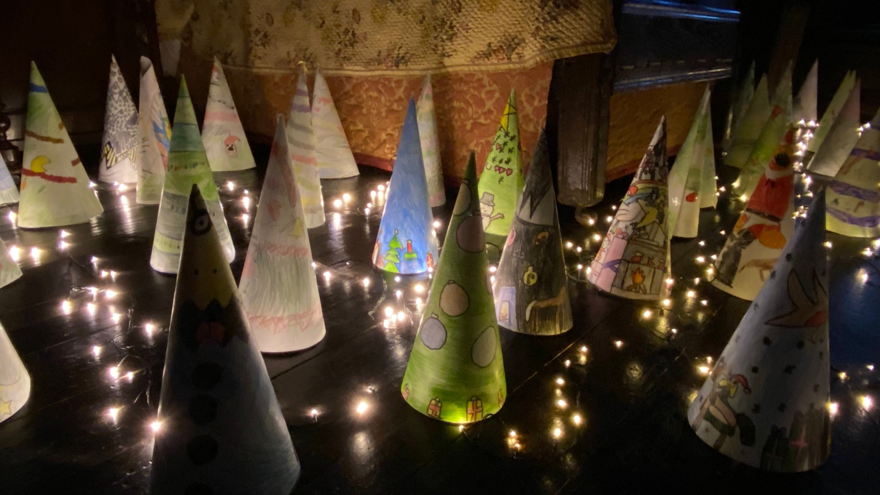Dark floor full of cones with twinkling lights threaded through