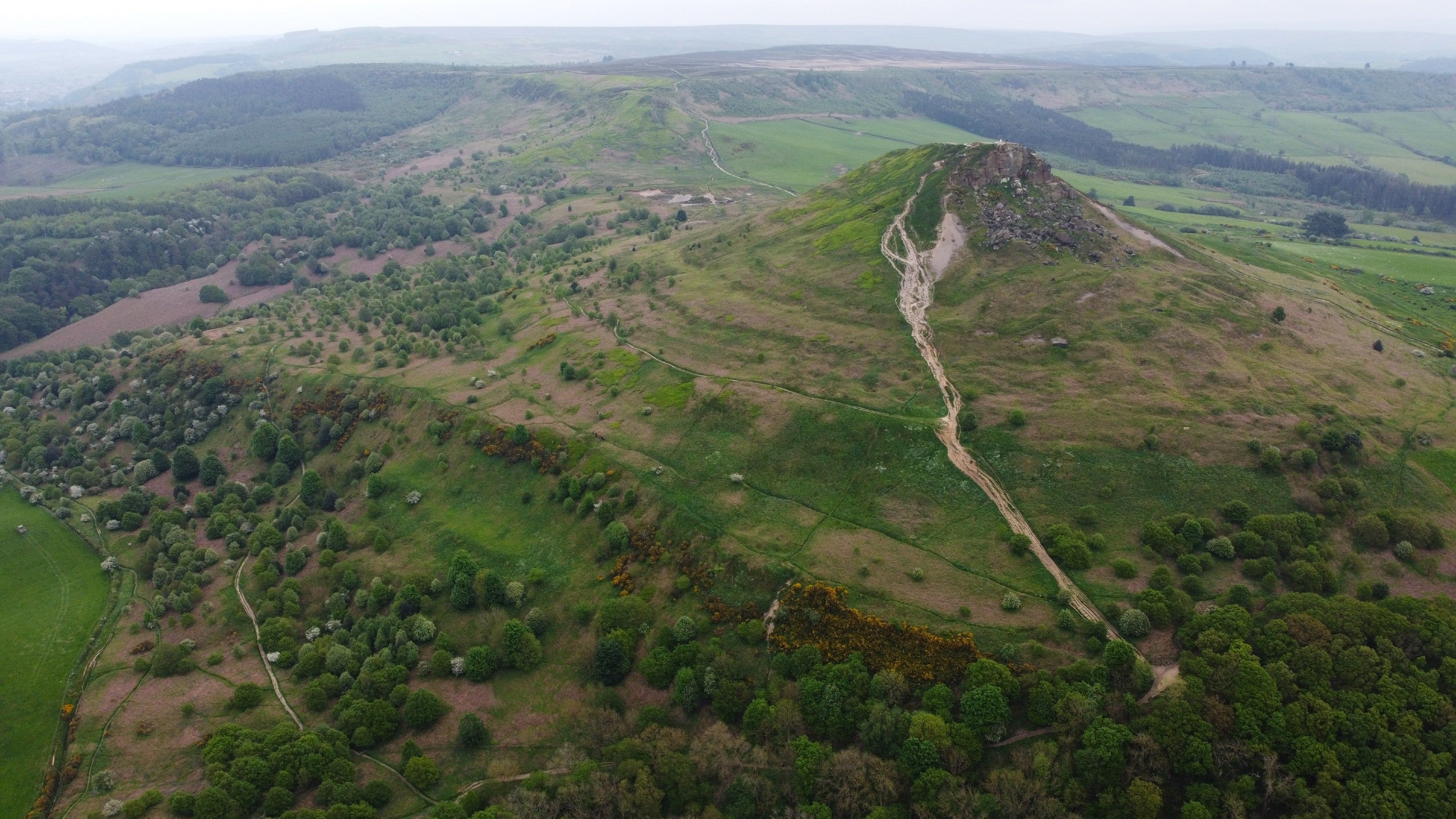 Large hill in the wider landscape with damaged paths