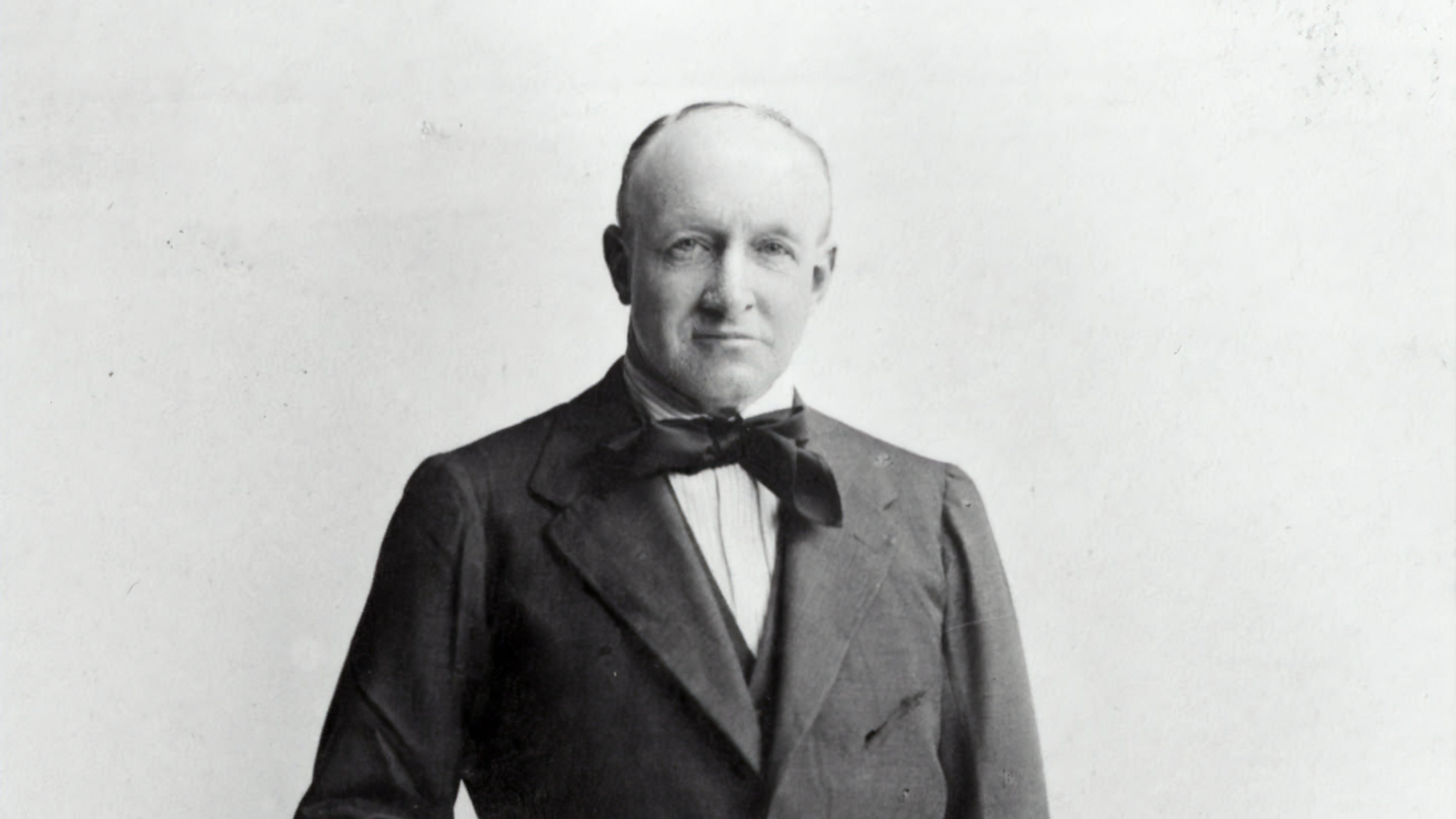 Historic black and white photograph of a man in a suit