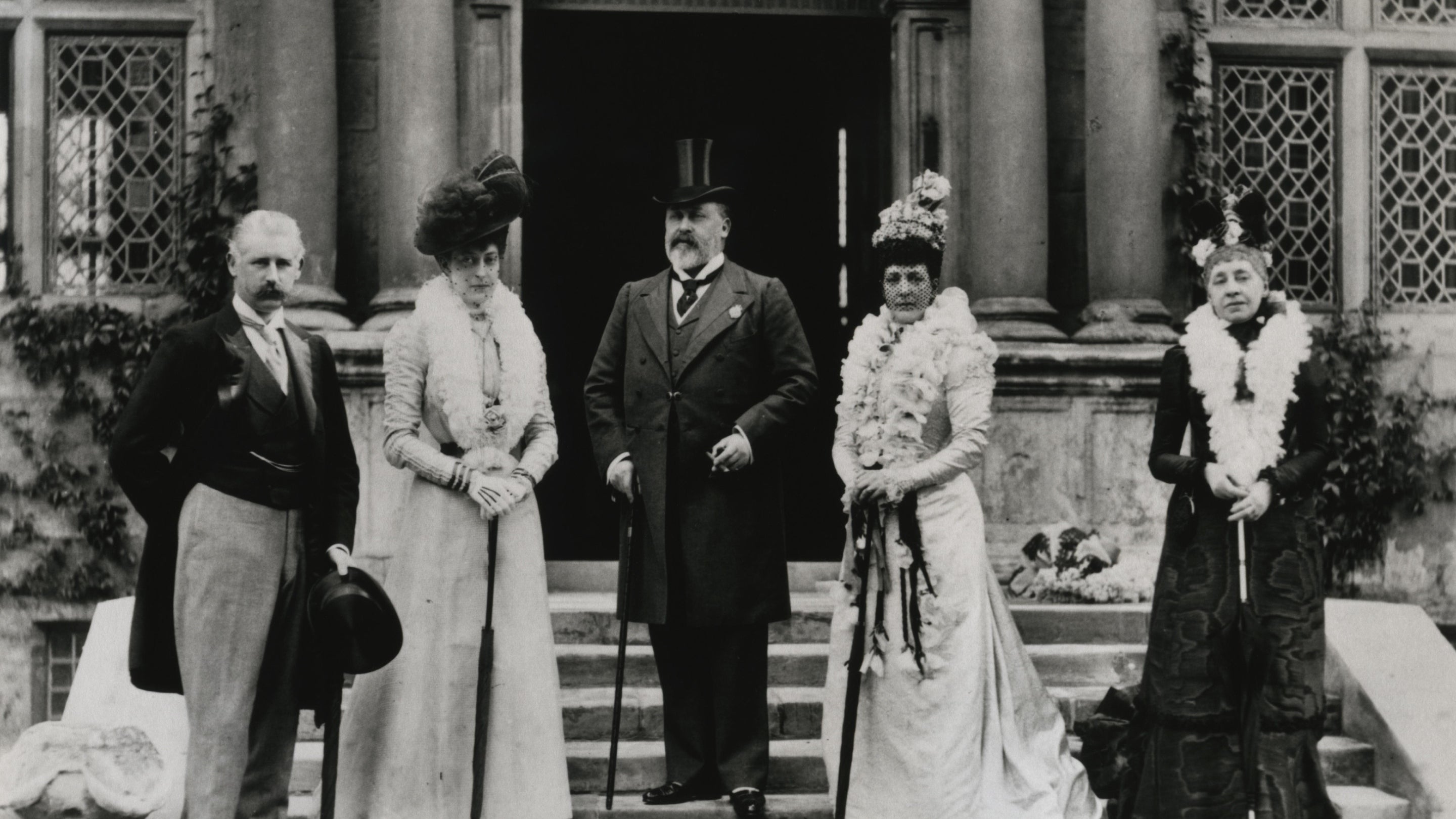 Black and white images of well dressed men and women in front of a grand door
