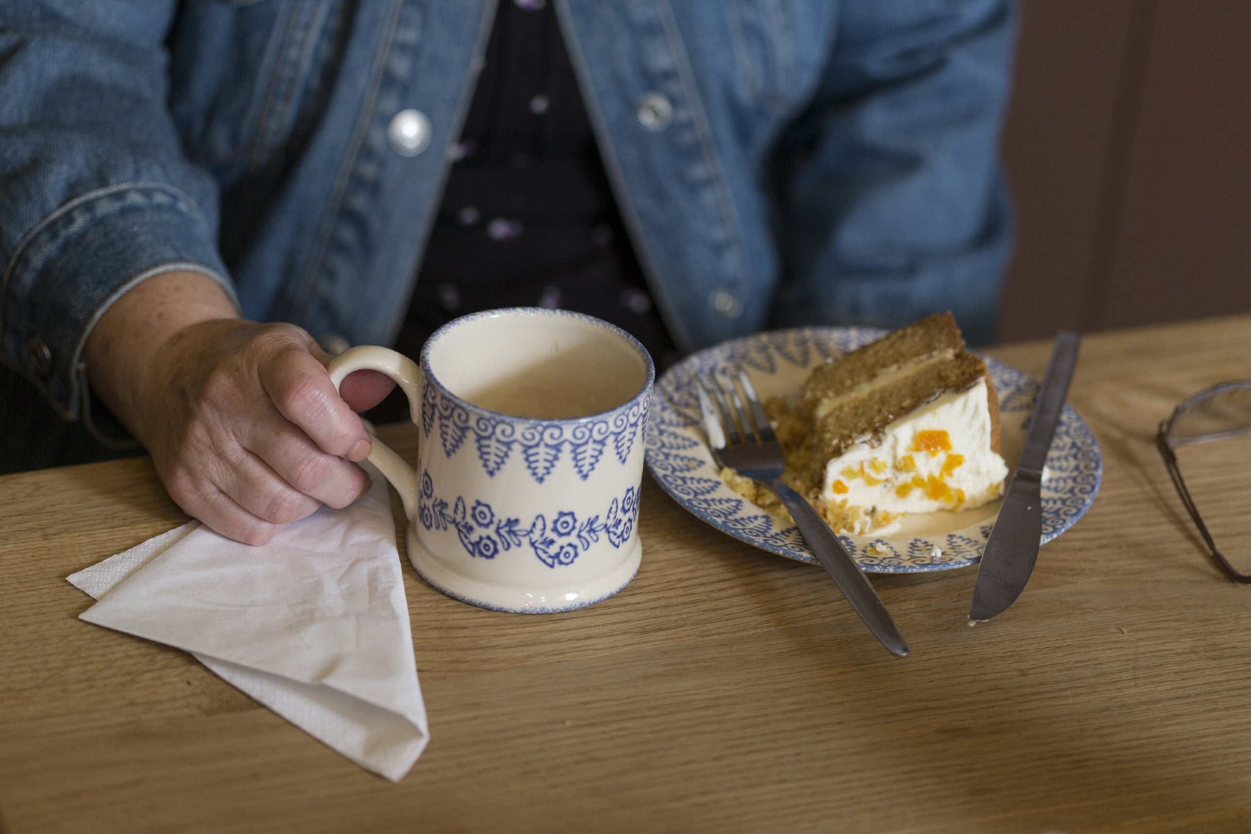 A visitor enjoying tea and cake in the tea-room