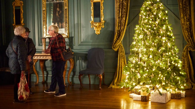 Visitors and a Christmas tree in the Blue Drawing Room at Treasurer's House, Yorkshire