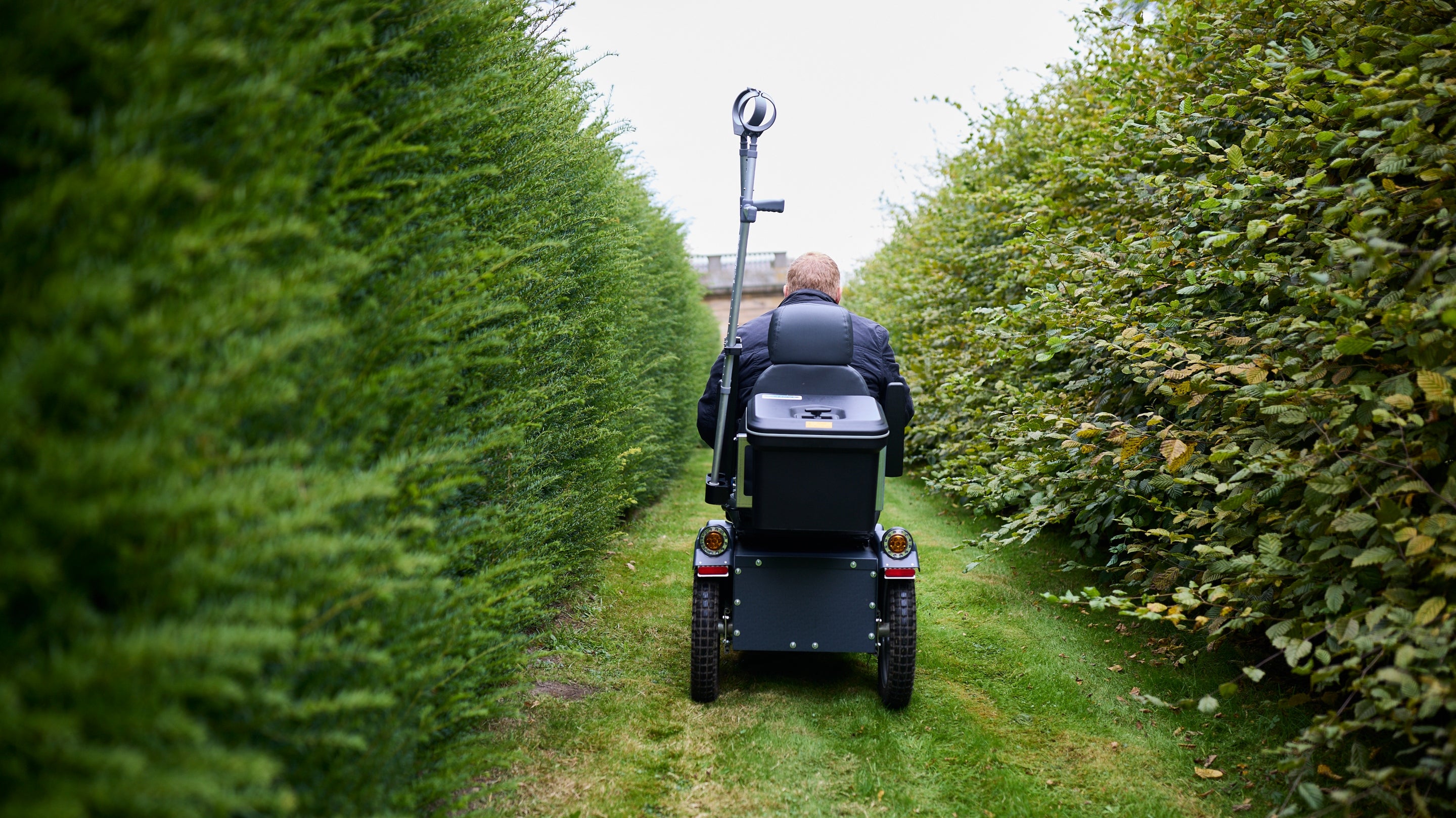 Visitor using a powered mobility scooter in the Union Jack Gardens