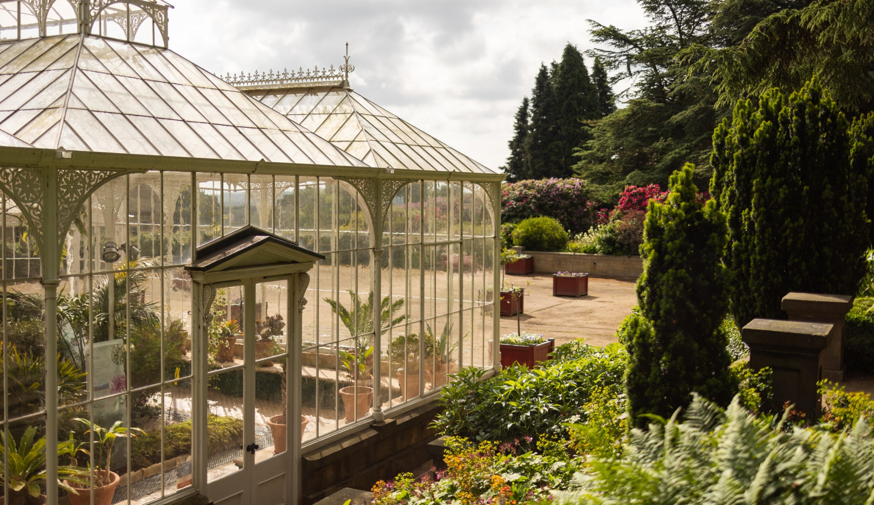 The outside of the Victorian Conservatory with flowers in the background