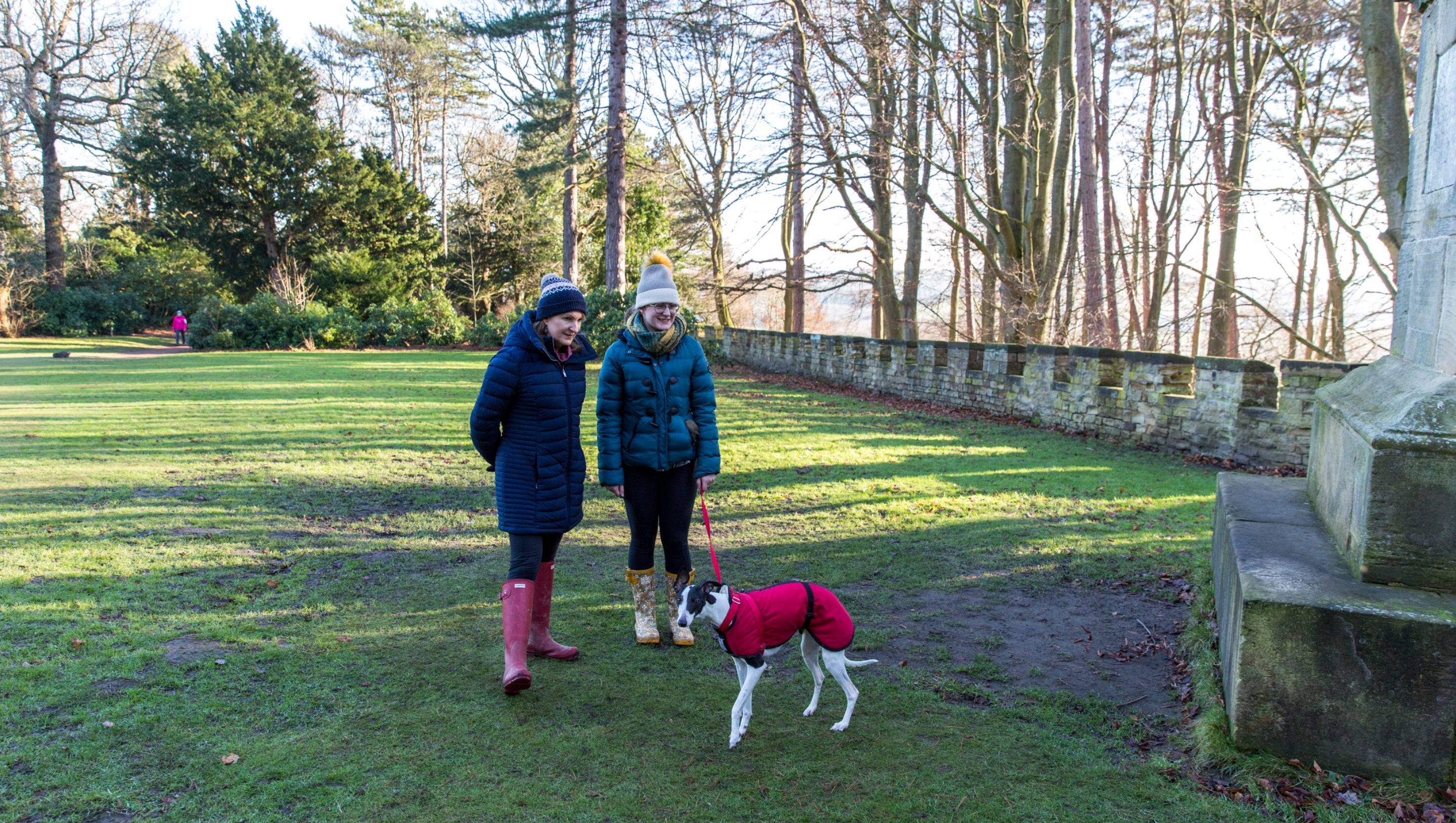Visitors by the Sun monument and battlement walls at Wentworth Castle Gardens