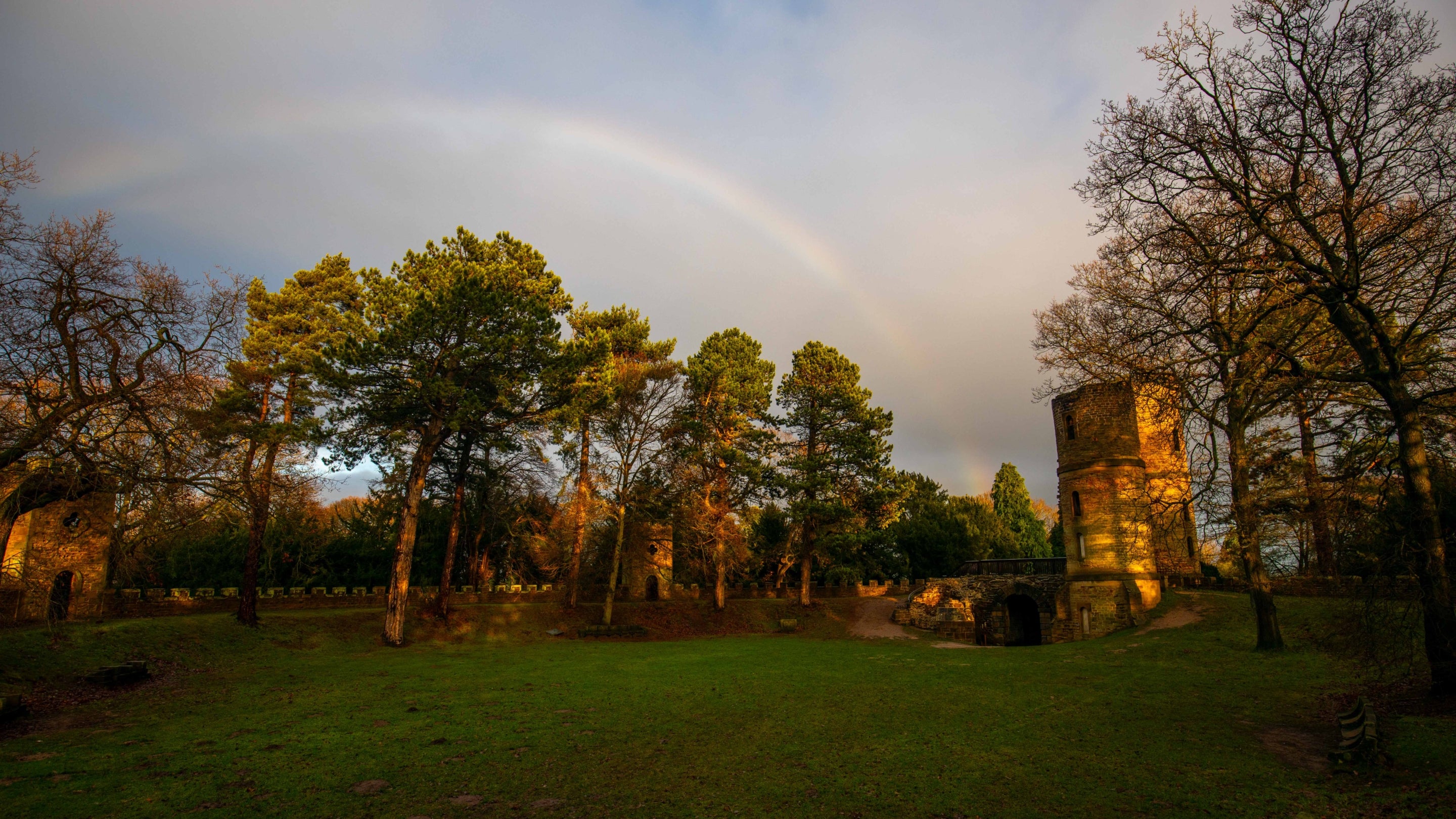 A rainbow over the trees and tower at Stainborough Castle